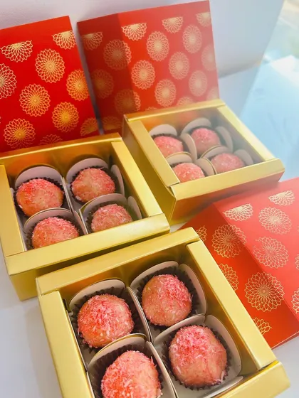 These are my Rose Coconut Laddoos, beautifully packed in festive red and gold boxes for Diwali. They are delicate, flavorful, and completely eggless.