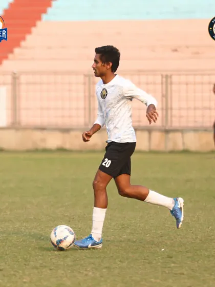 A player on the ball, focused and ready to contribute to the team's play.