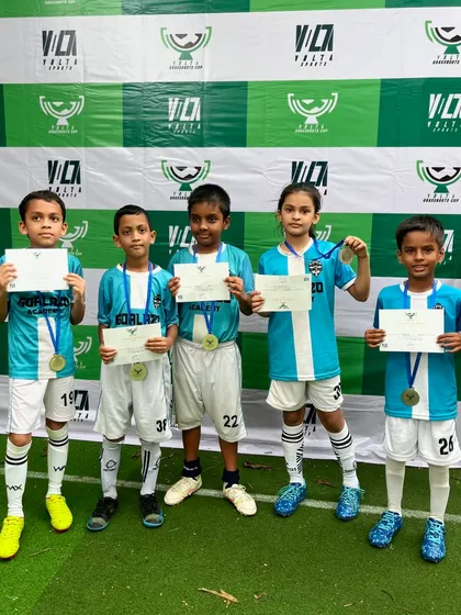 The Under-9 team proudly showing off their third place medals and certificates from the Grassroots Cup.