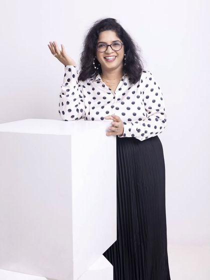 A classic black and white combination, elevated. We chose this polka dot shirt and pleated skirt to create a look that is both professional and full of personality, perfect for a personal branding shoot that needs to communicate both authority and approachability.