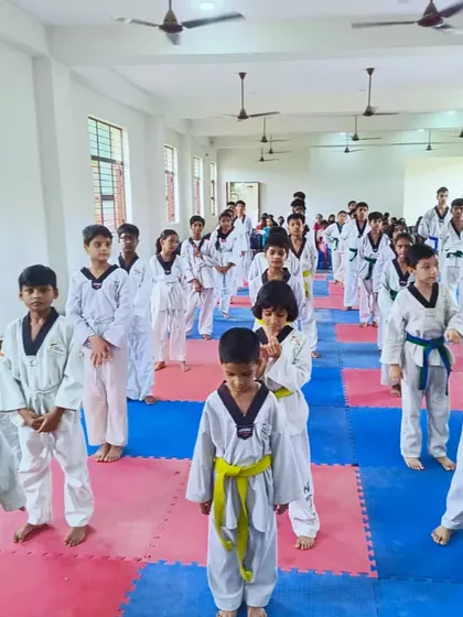 A large class of Taekwondo lovers at the Tiger Taekwondo Academy, all focused and ready to train.