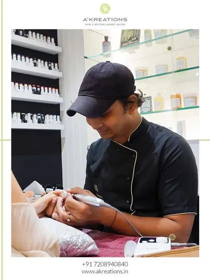 My nail artist, Azim, is focused on perfecting the nail shape and surface with a professional tool. This preparation is a crucial step for ensuring a flawless and long-lasting manicure.