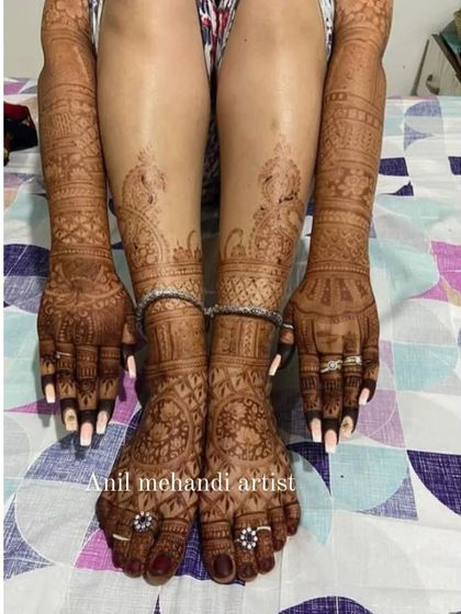 A full bridal mehendi set, with coordinated designs covering the hands, arms, feet, and legs. This ensures a cohesive and stunning look for the bride on her wedding day.