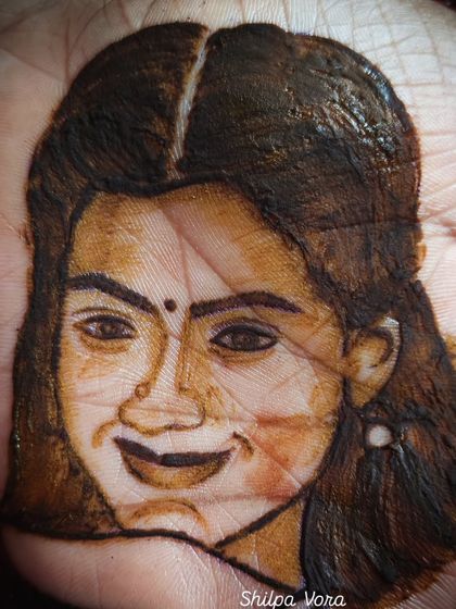 A portrait of the talented actress Rashmika Mandanna, created with henna. This showcases my ability to capture facial features and expressions in my artwork.