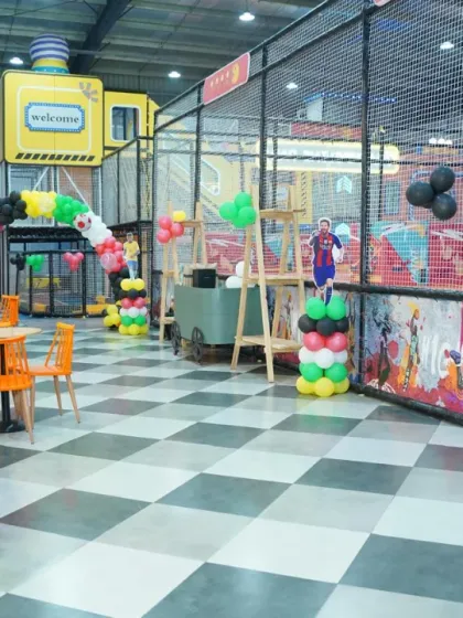 The play area decorated for a football fan's birthday, with cutouts of star players like Messi and Ronaldo.