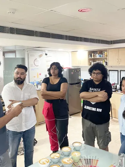 A group of students listening intently during a latte art and manual brewing workshop. This is a typical scene where we discuss theory before getting hands-on with the equipment.