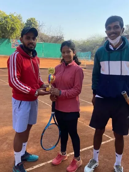 Pakhi Bisht celebrating her U-14 Doubles Runner-Up achievement with her coaches.
