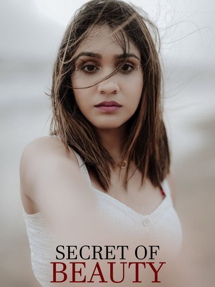 This close-up beach portrait has an editorial feel, with the text overlay adding a "secret of beauty" theme. It's a great example of a beauty-focused shot in a natural environment.