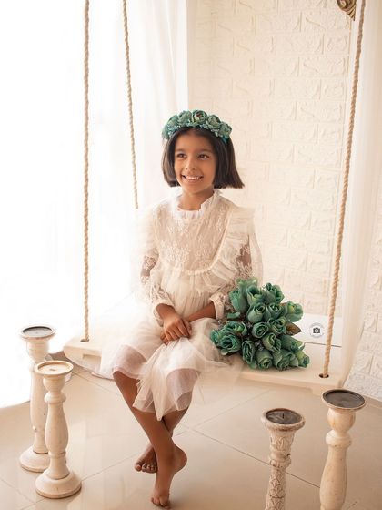 A happy and bright portrait on our classic white studio swing. The simple setup and her joyful smile are a perfect combination.