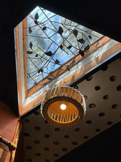 A skylight with a decorative grill made from leftover rebars, surrounded by a filler slab ceiling, demonstrating our commitment to upcycling and creative reuse.