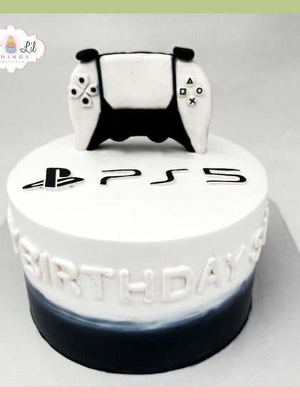 A modern PS5-themed cake with a black and white ombre effect, perfect for a gamer's birthday.