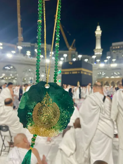 A luxurious car hanging in an emerald green and gold design, featuring Ayat ul Kursi. It's paired with a matching crystal tasbeeh, making it a beautiful spiritual accessory for your vehicle.