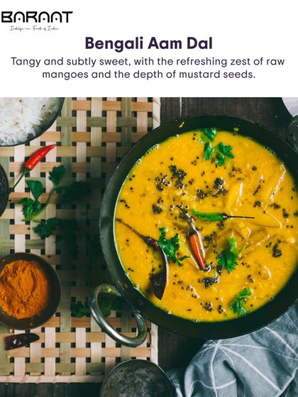 A beautiful top-down shot of our Bengali Aam Dal, showcasing the vibrant yellow colour and the tempering of spices.