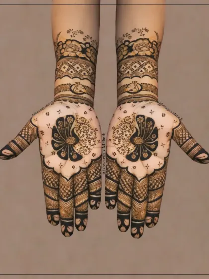 A classic bridal design featuring symmetrical peacock motifs on the palms. The detailed patterns on the fingers and wrists make this a timeless choice for any bride.
