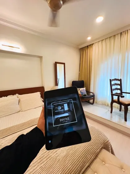 This minimalist bedroom at the NRI Complex in Seawoods was designed for pure relaxation. We focused on a clean, clutter-free layout with a neutral color palette and warm wood accents to create a serene and comfortable personal space.