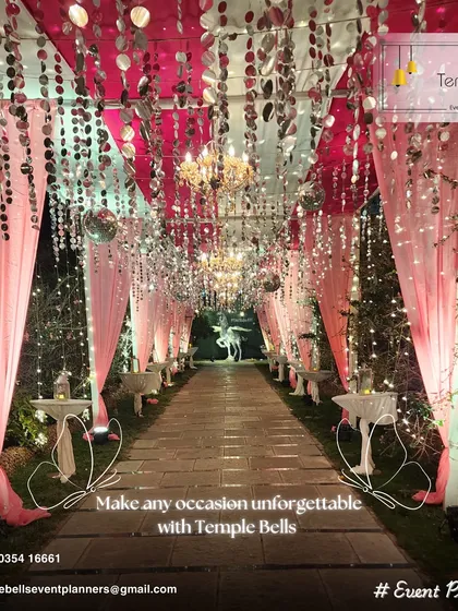 A magical walkway designed for an evening reception, creating an unforgettable entrance for guests. We used flowing pink drapes, hanging crystals, and shimmering discs to catch the light from the chandeliers and fairy lights.