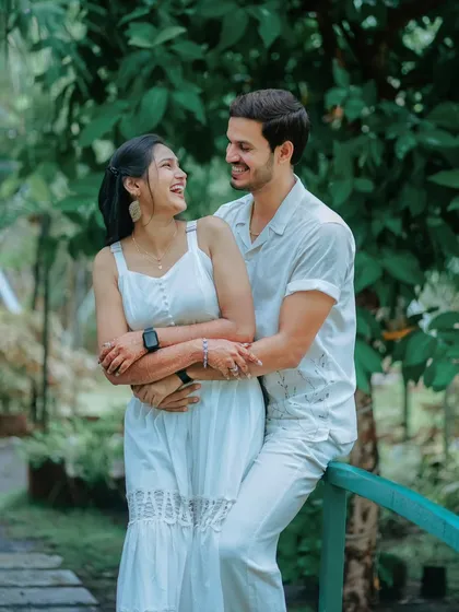 A candid moment of laughter and love. This photo of Suchita and Om Prakash leaning against a railing is natural, relaxed, and full of affection.