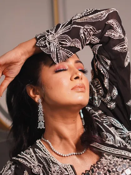 This artistic pose highlights the beautiful blend of colours on the eyelid. We teach how to seamlessly blend multiple eyeshadows to create a professional gradient effect.