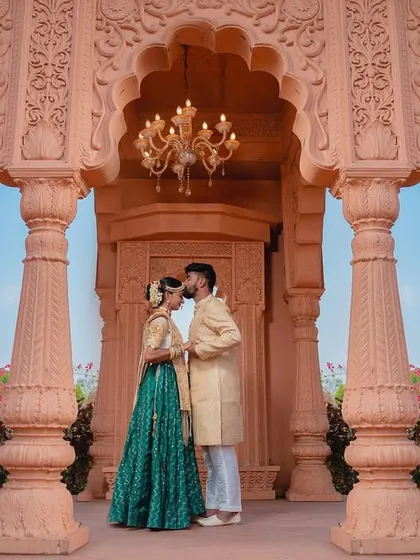 For couples who dream of a fairytale romance, I create scenes of pure grandeur. This shot, set against stunning royal architecture, captures a kiss that feels like a moment straight out of a classic love story.