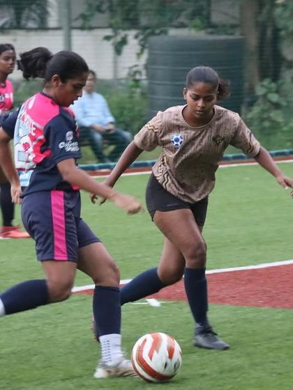 A player from our girls' team focused on the ball during a match in the TGIF x She Kicks Football League.