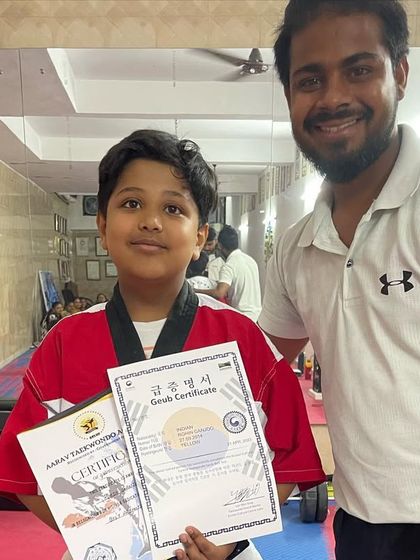 This student has earned his red belt certificate, a significant achievement on the path to black belt. His dedication is an inspiration to others.
