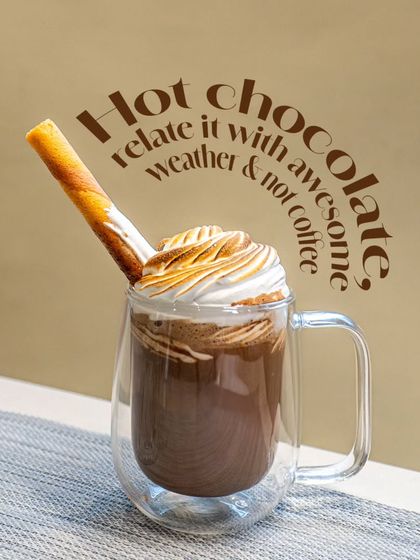 My hot chocolate is perfect for cozy weather. This one is served in a double-walled glass mug, topped with torched meringue and a wafer roll.