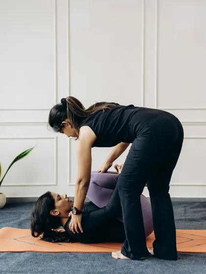 A gentle touch can make all the difference in a restorative pose. Here, I am helping a student release tension in their lower back and hips in Apanasana (Knees-to-Chest Pose), encouraging relaxation and surrender.