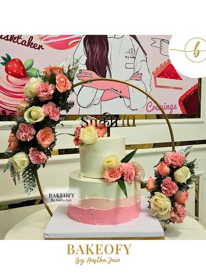 A beautiful 3.3kg two-tier fresh fruit cake, designed with a stunning fresh floral arrangement in a golden hoop. This design adds so much elegance and height to the celebration table.