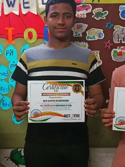 Three of our students holding their certificates of participation after a performance. We believe in recognizing every student's effort and courage to perform on stage.