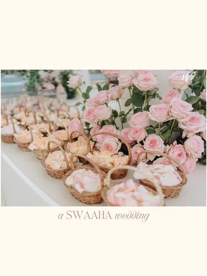 A collection of images from a dreamy Dubai wedding, featuring pastel rose floral arrangements, from the main arch to the small baskets of petals for guests.