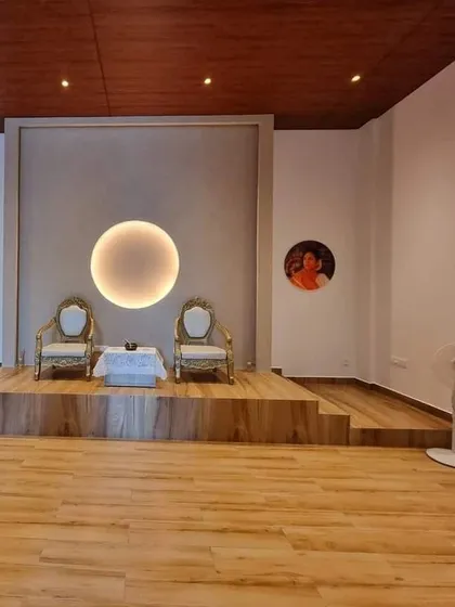 A view of the main stage and meditation hall in our new Spiritual Centre. The clean, minimalist design with portraits of us creates a serene and focused environment for spiritual practice.