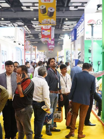 A long shot of the crowded aisle, giving a sense of the immense scale and visitor traffic at the expo.