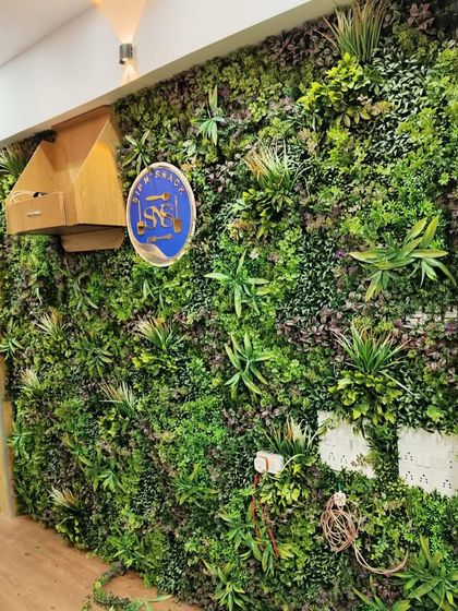This office installation includes a custom cutout for the company's logo and electrical wiring. We work with you to ensure the green wall integrates perfectly with your existing infrastructure.