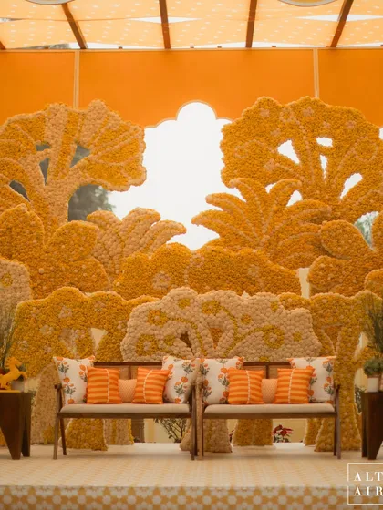 This Haldi ceremony, 'Kesar Sehar', was an ode to Indian craftsmanship and tradition, reimagined with a contemporary eye. The backdrop, a stunning landscape crafted entirely from marigolds, showcases my love for using traditional elements in new, artistic ways to create vibrant, joyful spaces.