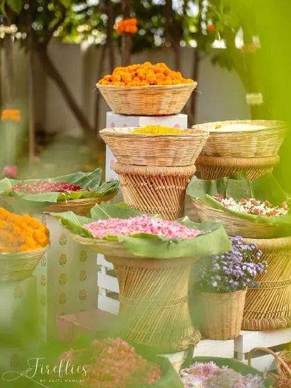 A beautiful corner with traditional cane baskets filled with fragrant, colorful flower petals for guests to use.