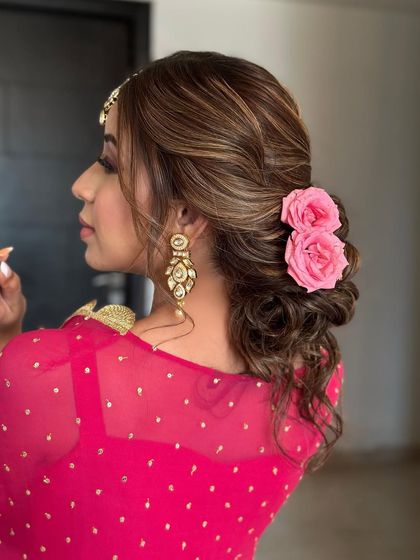 A low, soft textured bun with pink roses. This is a beautiful and romantic style that I love teaching in my classes.