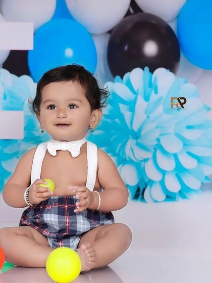 A baby boy plays with colorful balls in the Boss Baby setup. The mix of playful moments and stylish decor makes this theme a client favorite.