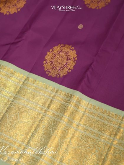 A vintage Kanjivaram in purple and blue, with large gold buttas, perfect for the festival season.