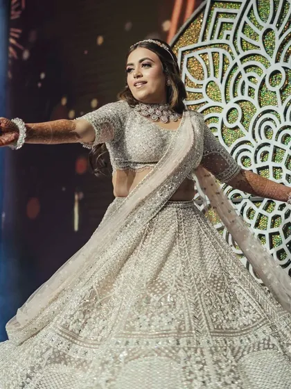 The bride, Ananya, shining in the spotlight during her solo performance. We designed the staging with a beautiful mandala backdrop to create a focal point and enhance the elegance of her dance.