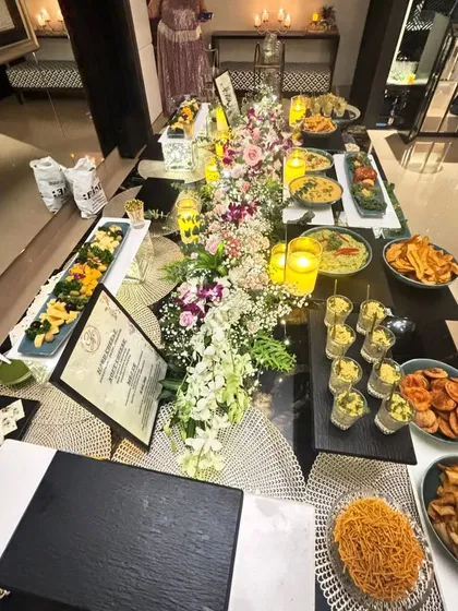 The ultimate Diwali spread. This long table is adorned with flowers, candles, and an incredible variety of our festive dishes, creating a true feast for the senses.