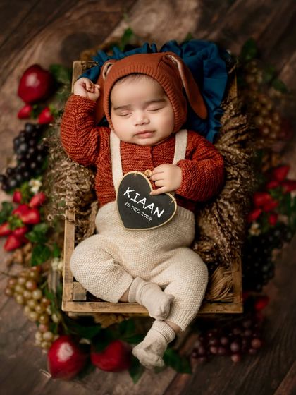 Personalizing the shoot with a small chalkboard heart showing the baby's name and birthdate is a wonderful way to create a custom announcement photo.