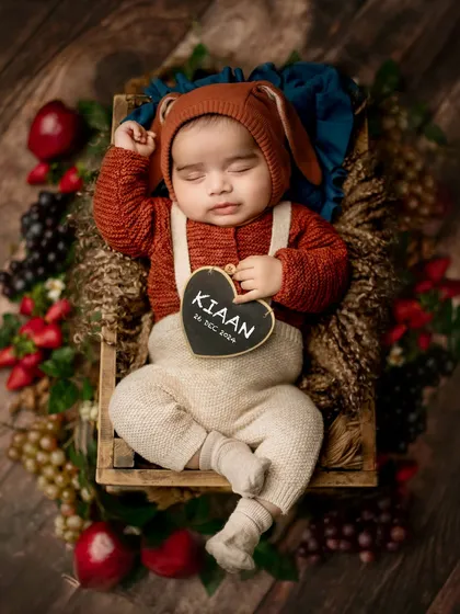 Personalizing the shoot with a small chalkboard heart showing the baby's name and birthdate is a wonderful way to create a custom announcement photo.