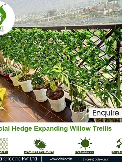 Another example of our expanding willow trellis, providing an instant green screen for this balcony railing, with potted plants arranged neatly in front.