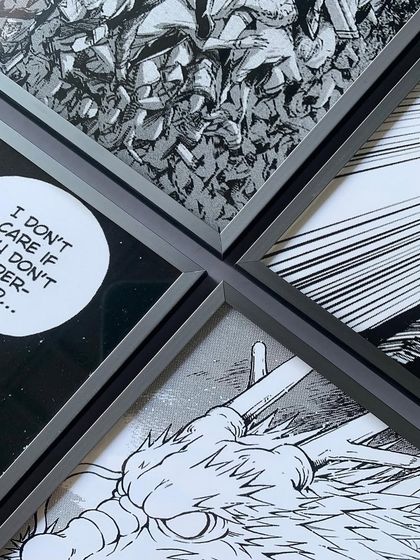 A close-up showing the precise alignment of four custom-framed manga panels. The sleek gray metal frames create a clean grid, turning comic art into a sophisticated wall display.