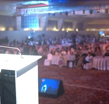 A view from my perspective on stage, looking out at a large, attentive audience during a corporate gala.