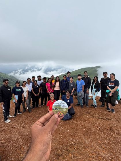 Another shot of our happy group at the Netravati summit, proudly holding the trek badge. It's all about the shared experience.