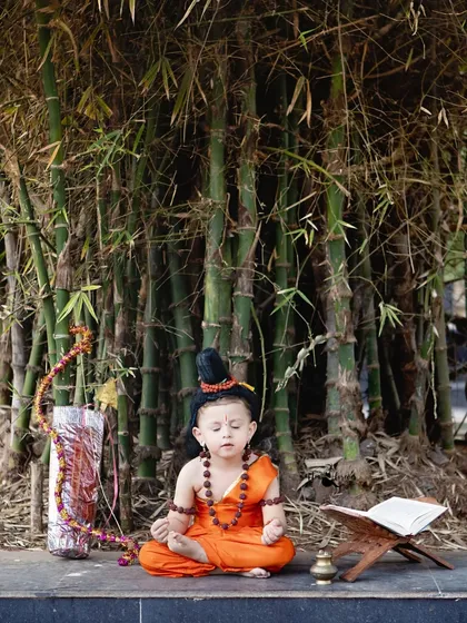 Finding peace and serenity. This shot captures a meditative moment during our outdoor Lord Ram themed birthday shoot, set against a backdrop of bamboo.