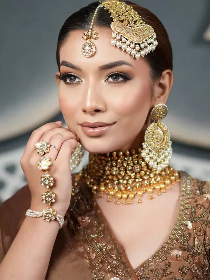 This close-up shows the flawless makeup and the clean lines of the hairstyle, creating a look of pure, understated elegance.