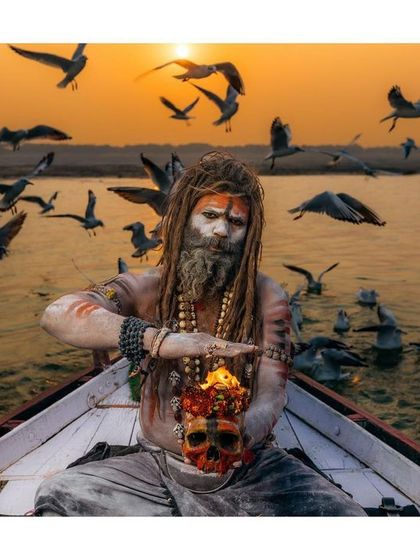 An Aghori sadhu performs a ritual with a skull and fire while floating on the Ganga at sunset. This is one of the most intense and visually striking spiritual practices I've ever witnessed.