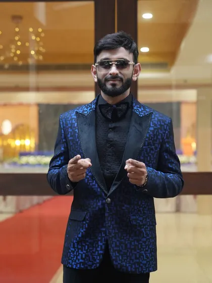 This photo, taken at a hotel before an event, shows another angle of the custom blue tuxedo. I'm always camera-ready, whether on the red carpet or interacting with guests.